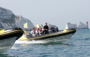 A speed boat on the Solent with the white cliffs of Dover in the background