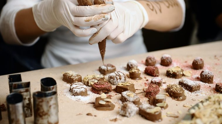 Someone making chocolates during a virtual chocolate making event