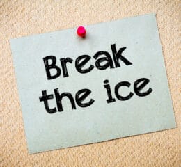 Piece of paper pinned to a board saying 'break the ice'