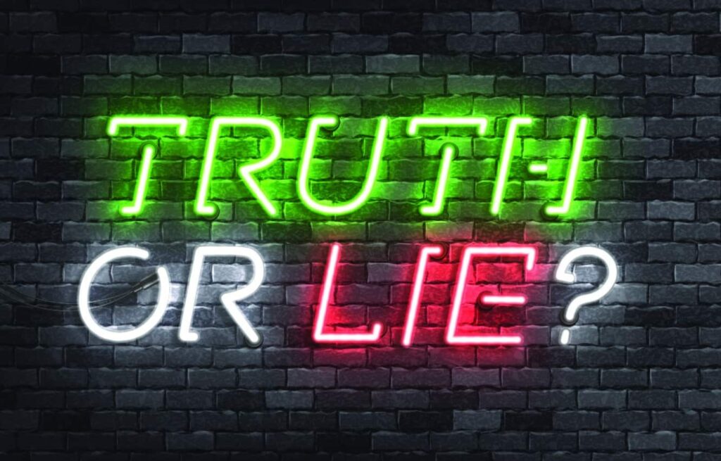 Corporate event ice breakers. Neon sign on a black brick background saying 'truth or lie' 
