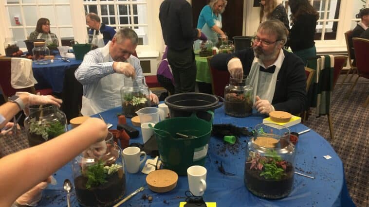 Group taking part in a terrarium making mindfulness team building activity